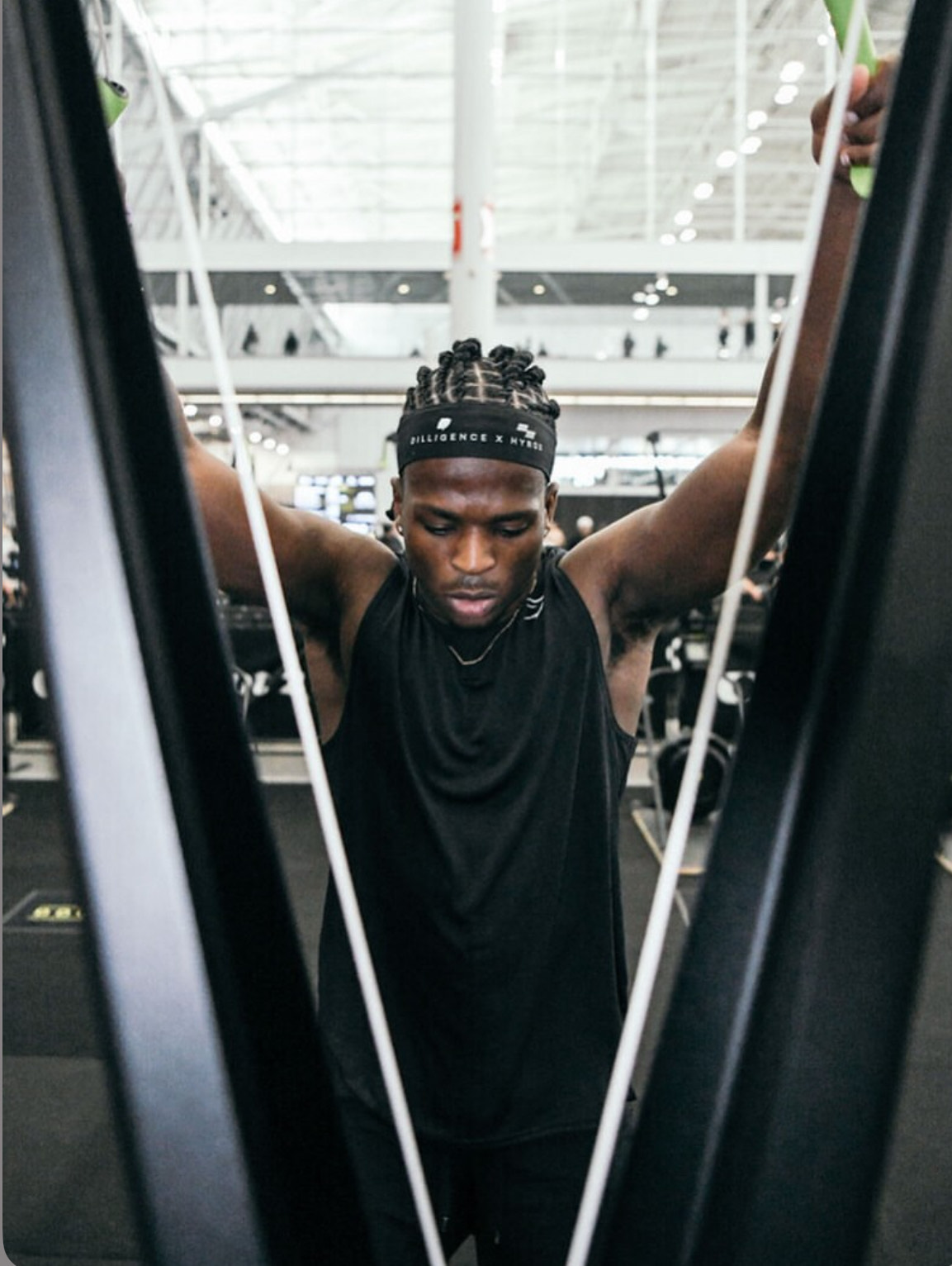 Community member performing hanging grip exercise during HYROX training