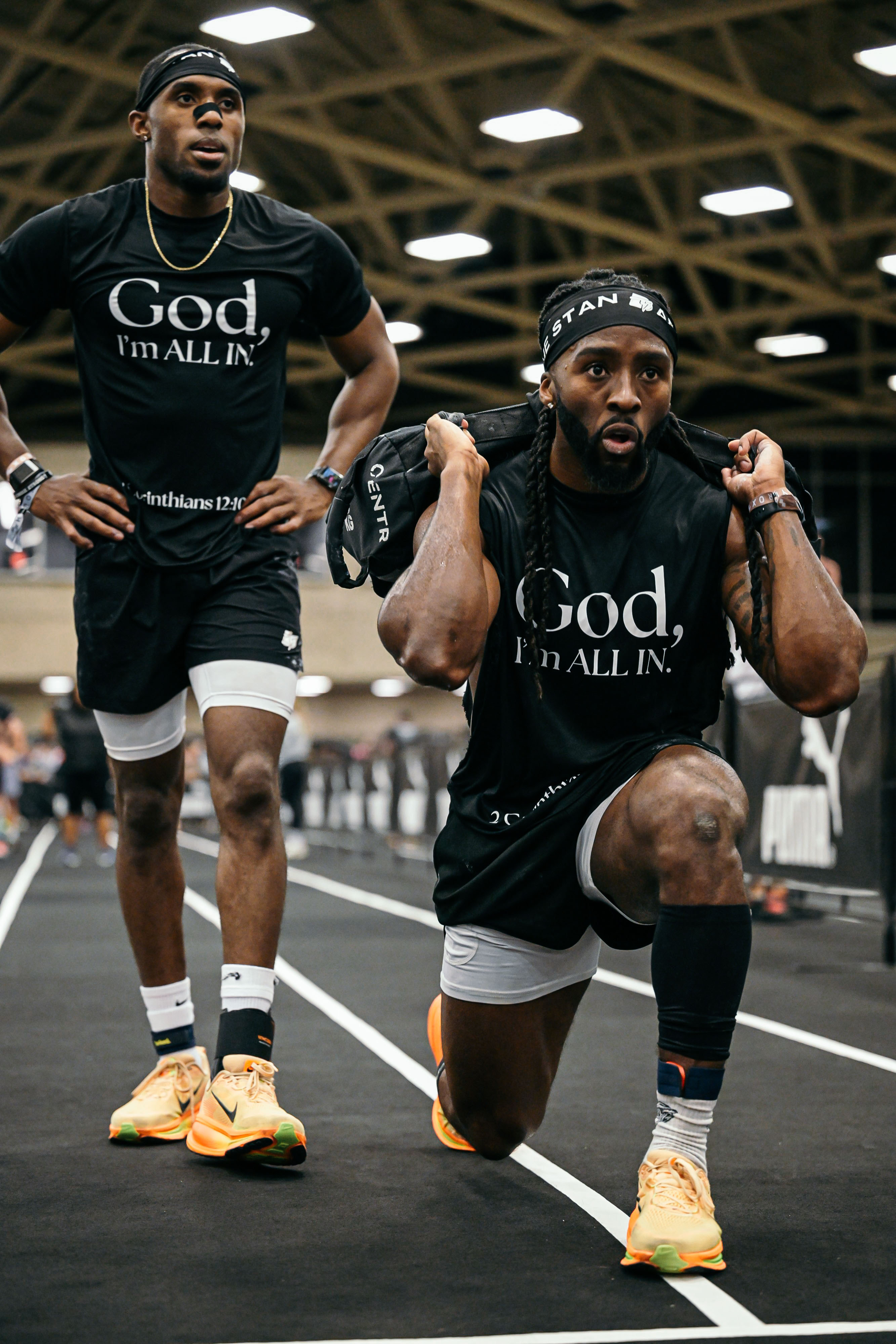 Community member performing weighted lunges during HYROX competition