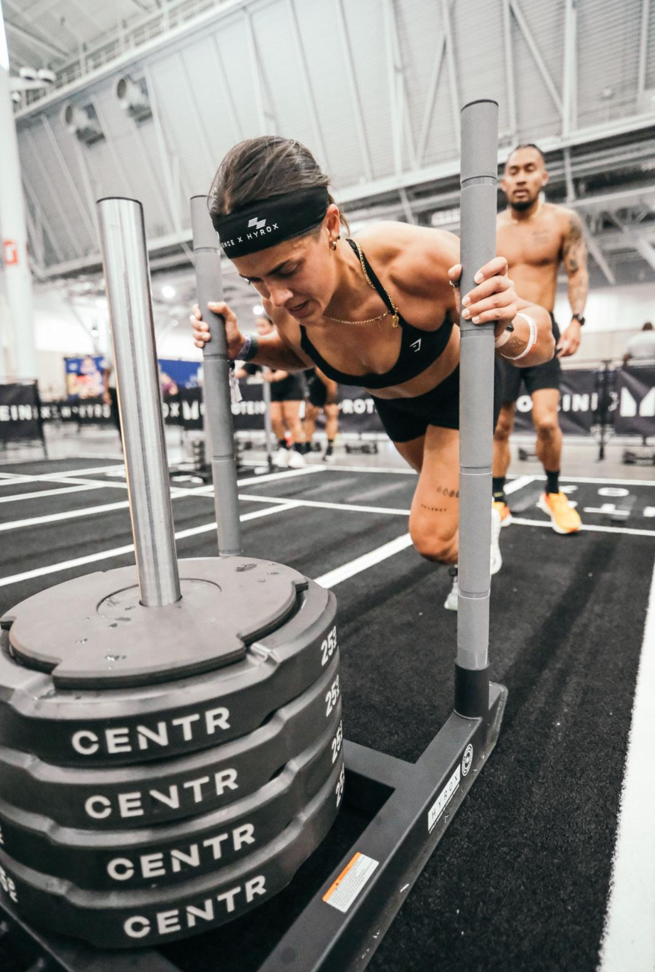 HYROX athlete performing sled push during competition